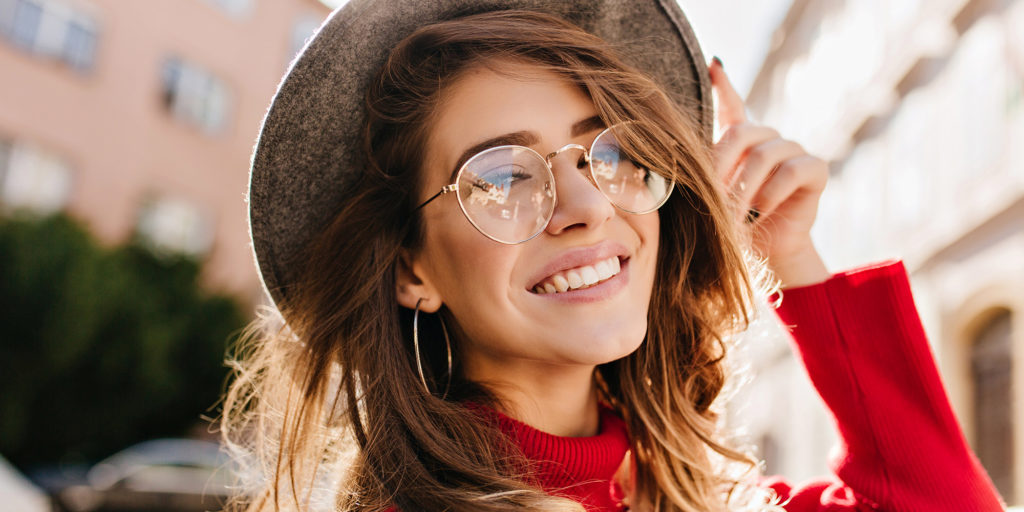 Very nice lady wearing a hat and glasses red blouse very nice smile