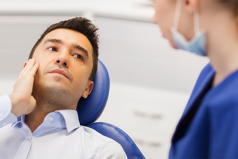 Nice guy in pain looking at dentist for help