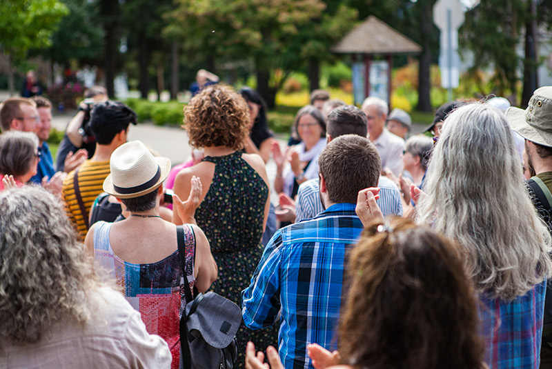 a lot of people outside at a community event
