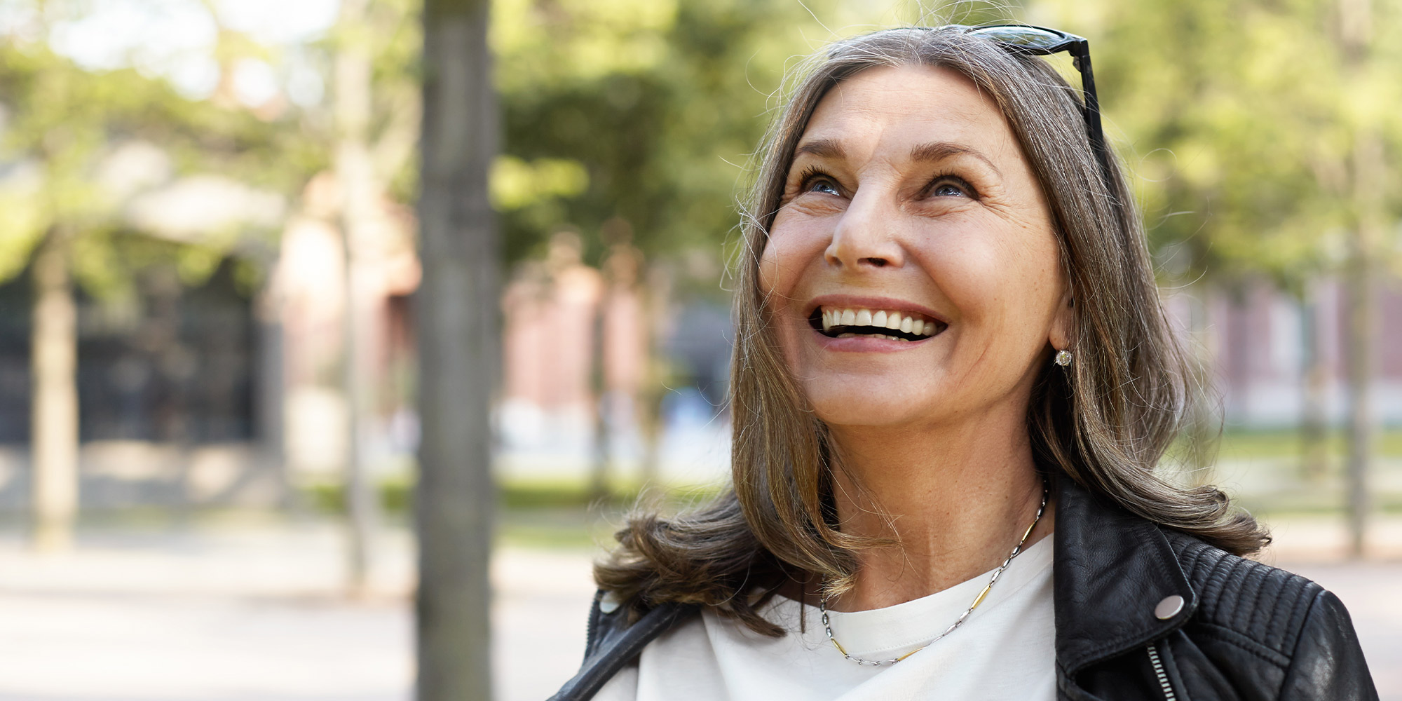 Very nice lady out side smiling looking up