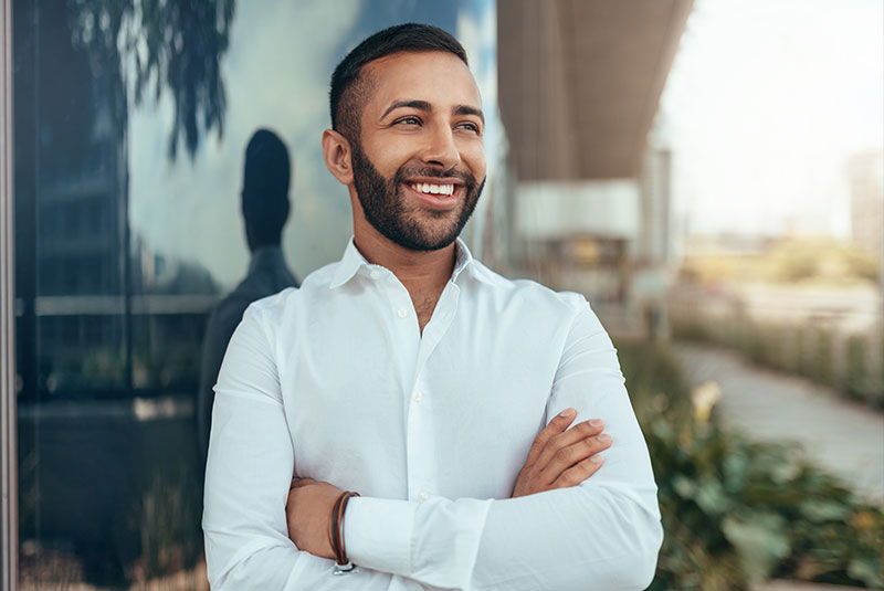 young man smiling outside